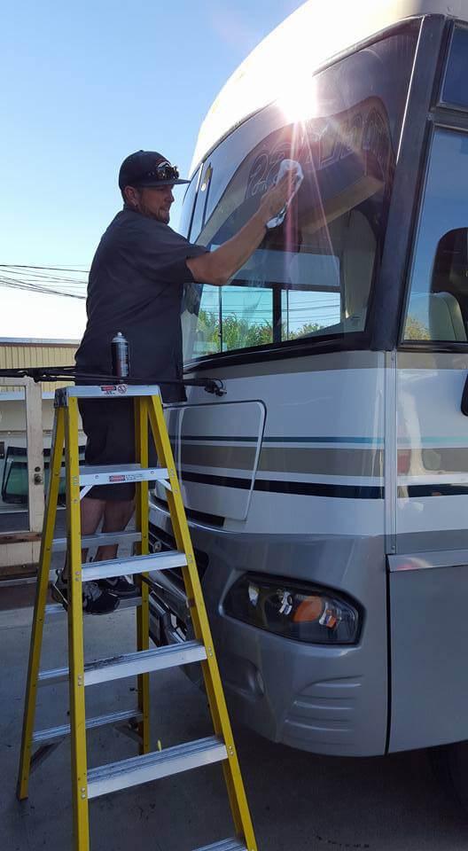 cal state auto_technician fixing glass in RV